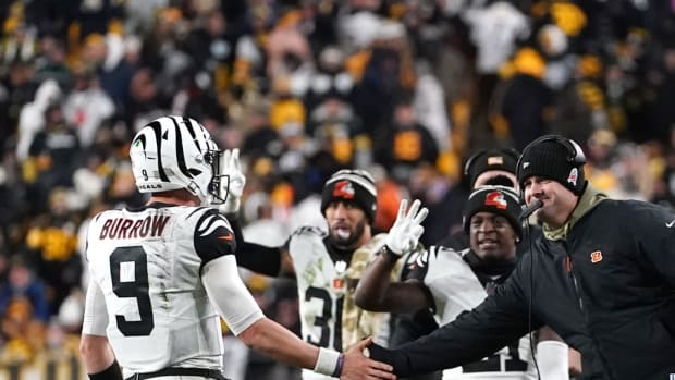 Nov 20, 2022; Pittsburgh, Pennsylvania, USA; Cincinnati Bengals quarterback Joe Burrow (9) is congratulated by Cincinnati Bengals head coach Zac Taylor after a touchdown in the fourth quarter against the Pittsburgh Steelers at Acrisure Stadium. Mandatory Credit: Kareem Elgazzar-USA TODAY Sports-The Cincinnati Enquirer